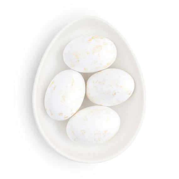 round dish with gold and white chocolate eggs inside