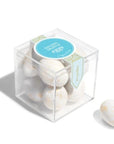 clear candy cube with gold and white chocolate eggs inside