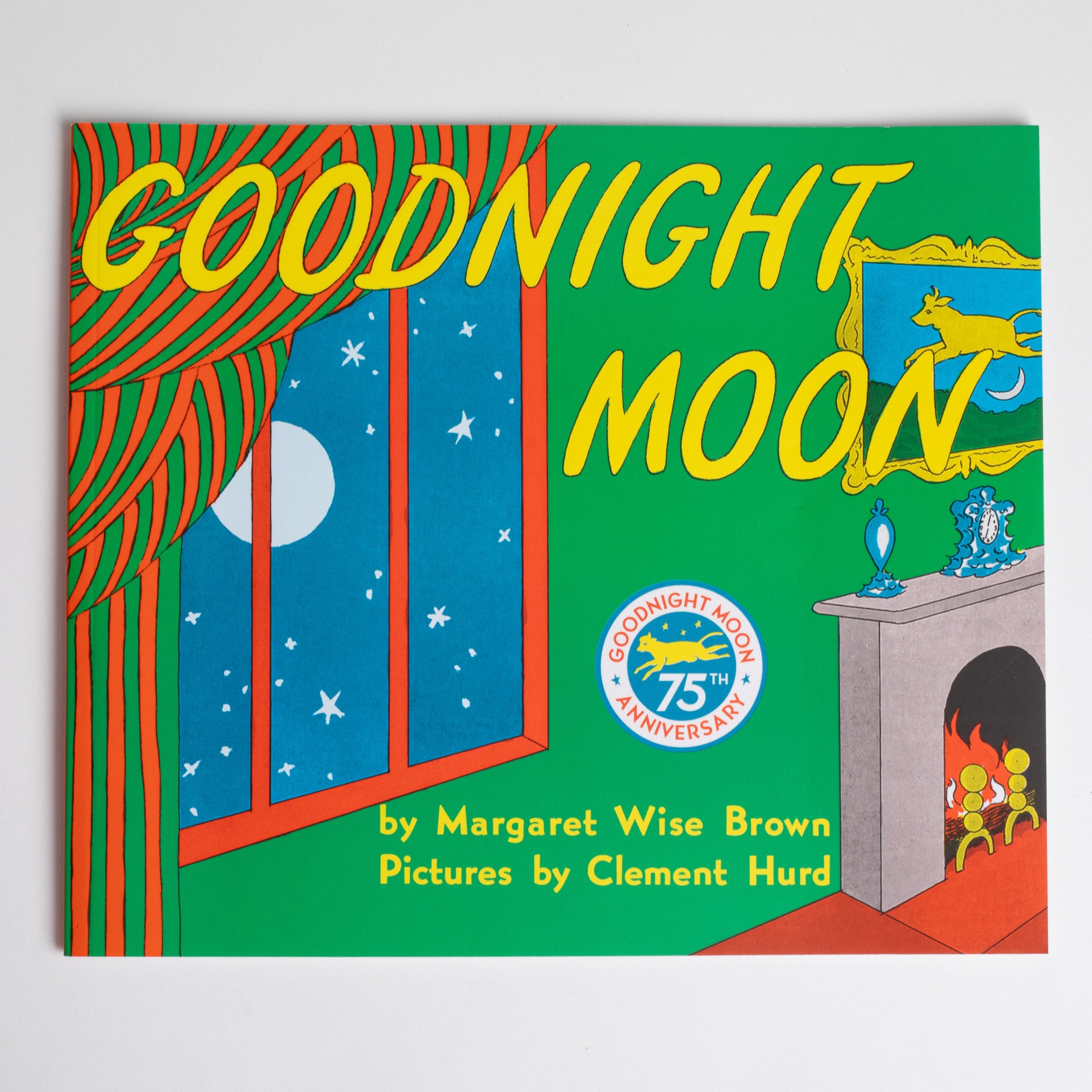 goodnight moon written in yellow text. the book is colorful with green, blue, orange, red, yellow. There is a window that shows the white moon