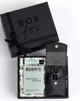 Mini Black BOXFOX gift box packed with rudy's soap body bar, salt and stone mint lip balm and leather manicure kit