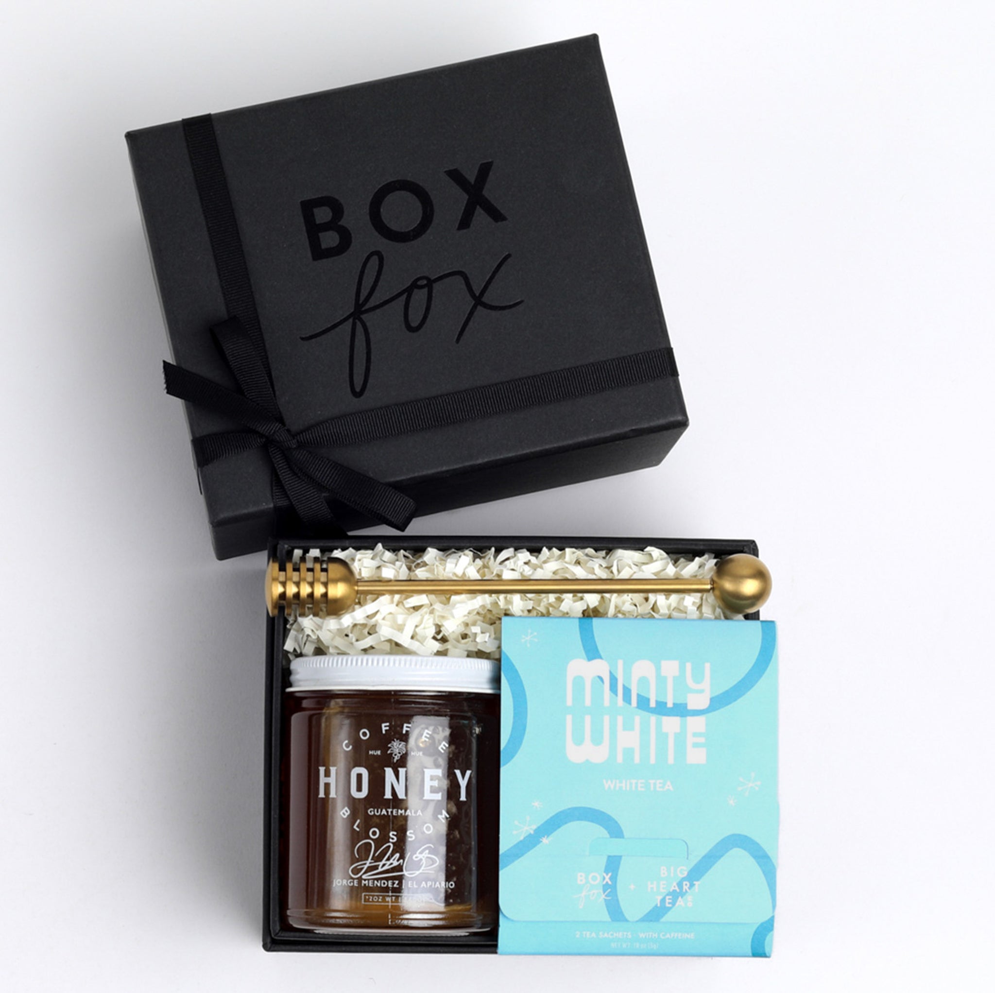 BOXFOX Matte Black gift box packed with gold honey dipper, jar of honey and blue minty why tea sachet