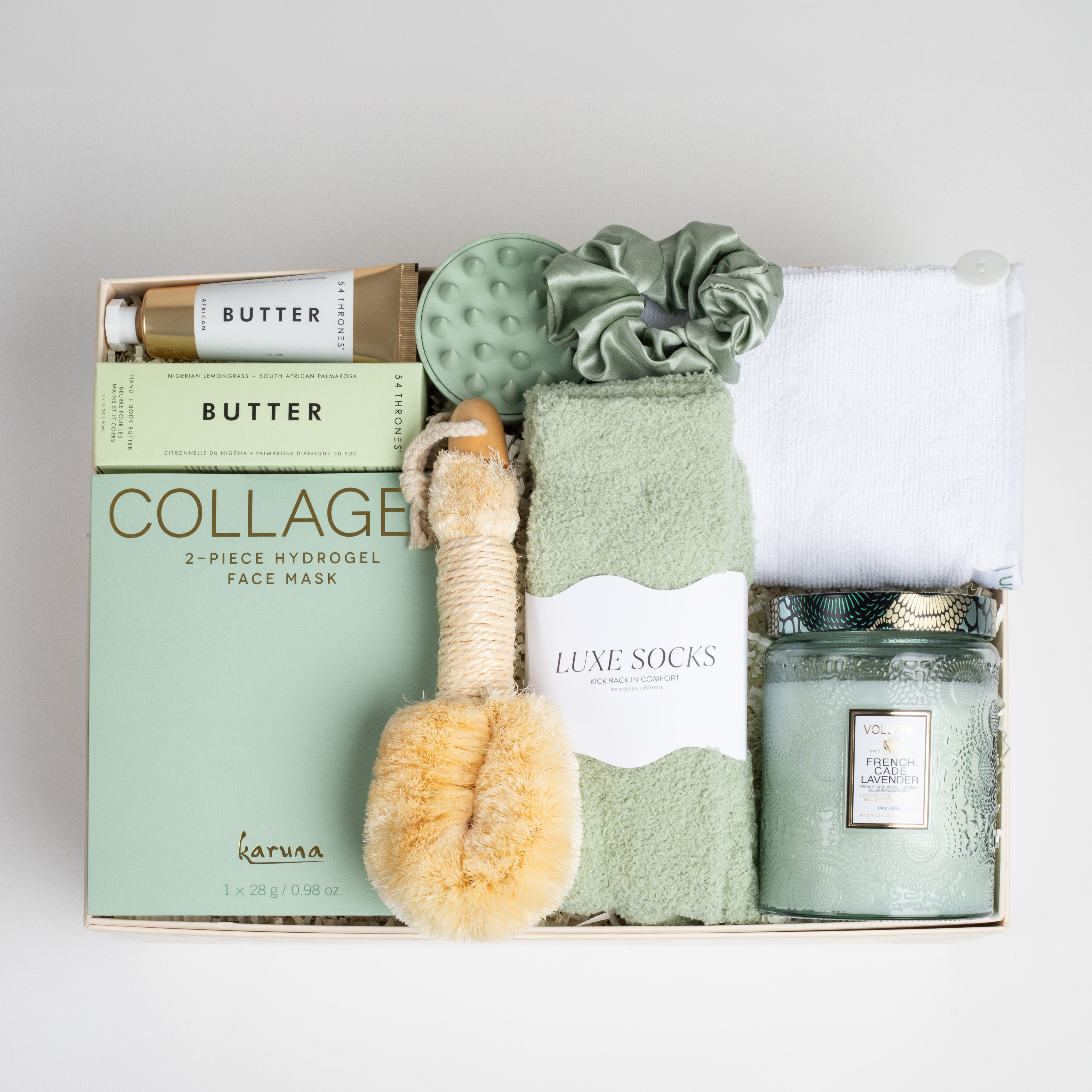 The GREEN GODDESS gift box in creme, including sage luxe socks, large candle, dry brush, collagen face mask, hand cream, scalp scrubber, silk scrunchie and hair towel.