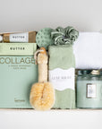 The GREEN GODDESS gift box in creme, including sage luxe socks, large candle, dry brush, collagen face mask, hand cream, scalp scrubber, silk scrunchie and hair towel.