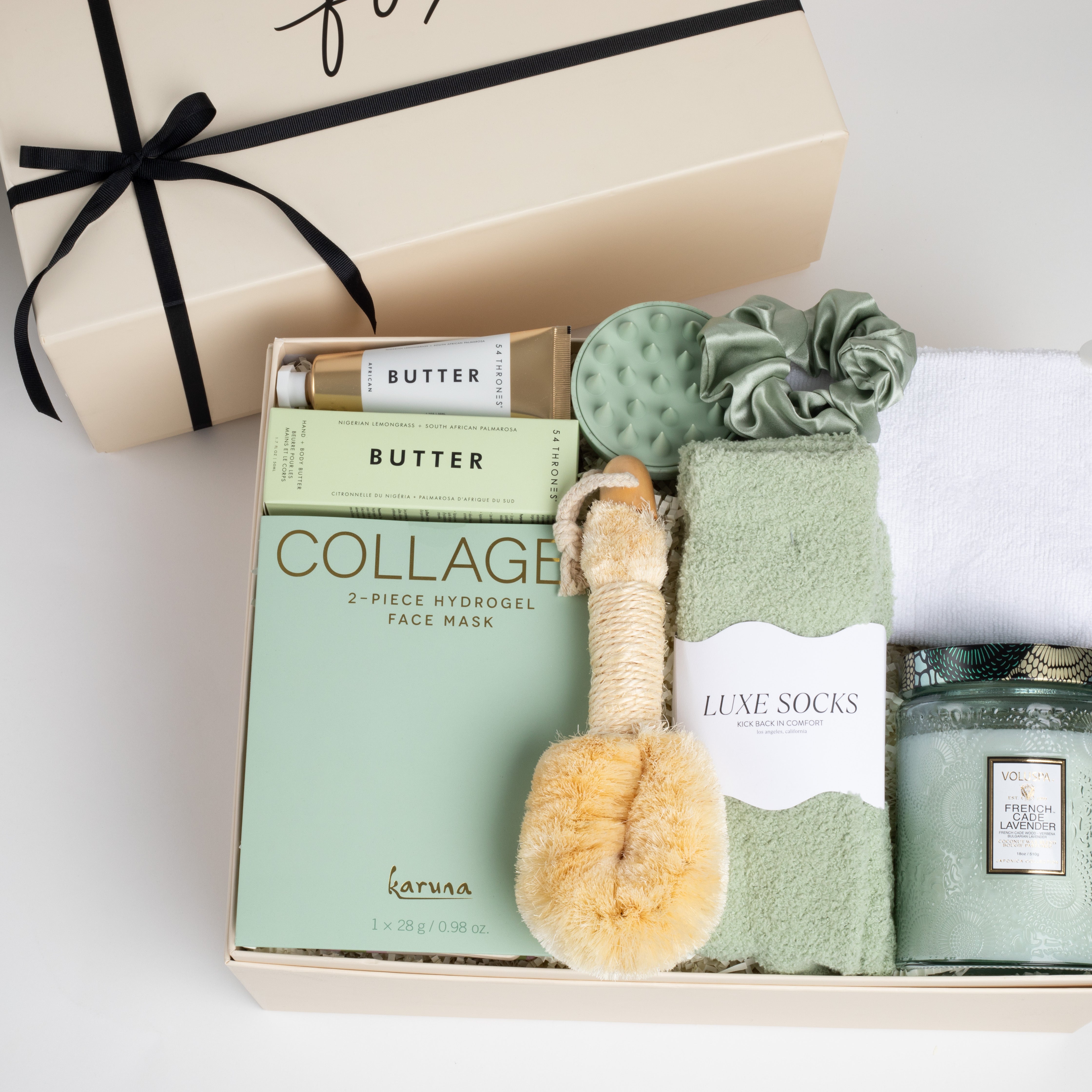 The GREEN GODDESS gift box in creme, including sage luxe socks, large candle, dry brush, collagen face mask, hand cream, scalp scrubber, silk scrunchie and hair towel.