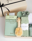 The GREEN GODDESS gift box in creme, including sage luxe socks, large candle, dry brush, collagen face mask, hand cream, scalp scrubber, silk scrunchie and hair towel.