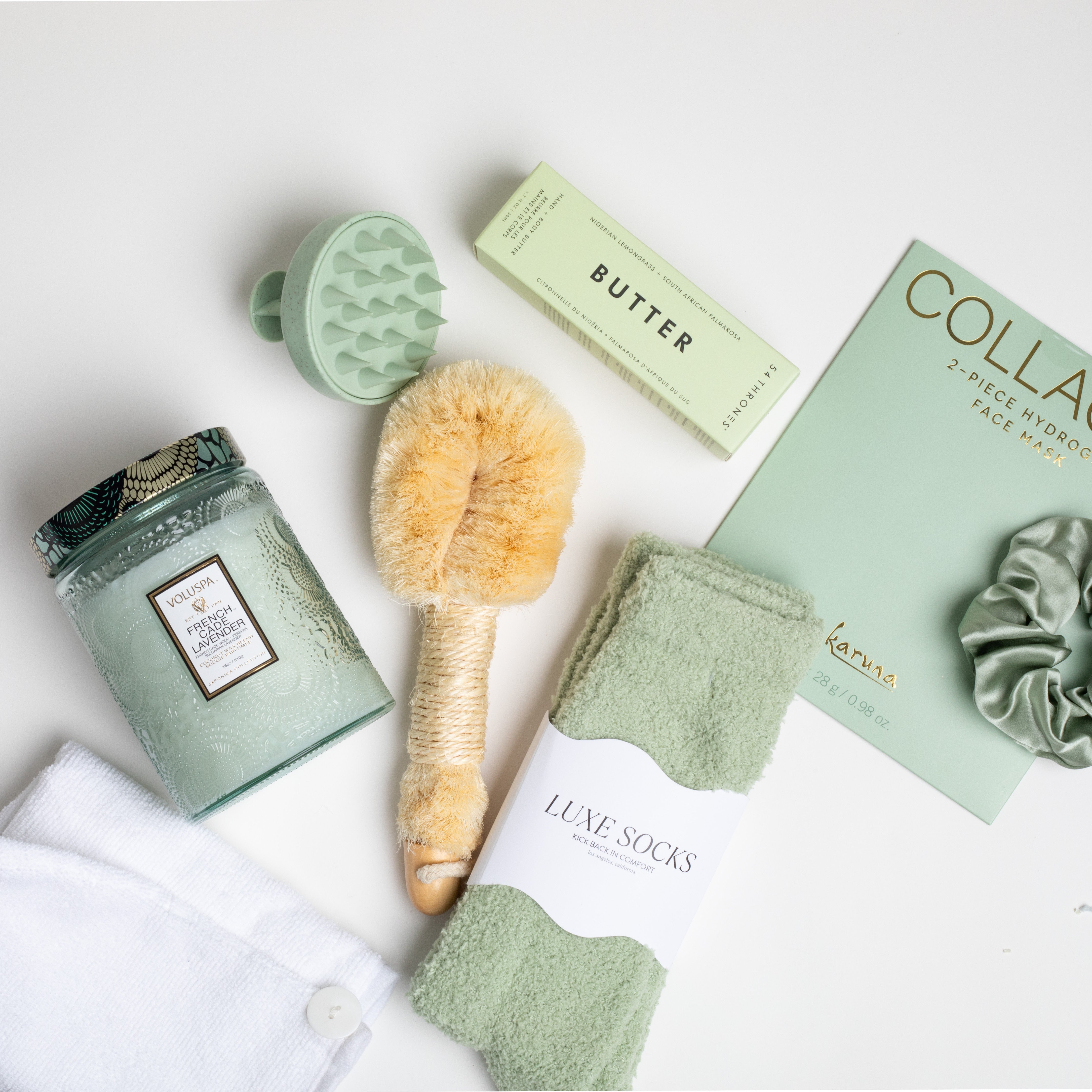 The GREEN GODDESS gift box in creme, including sage luxe socks, large candle, dry brush, collagen face mask, hand cream, scalp scrubber, silk scrunchie and hair towel.