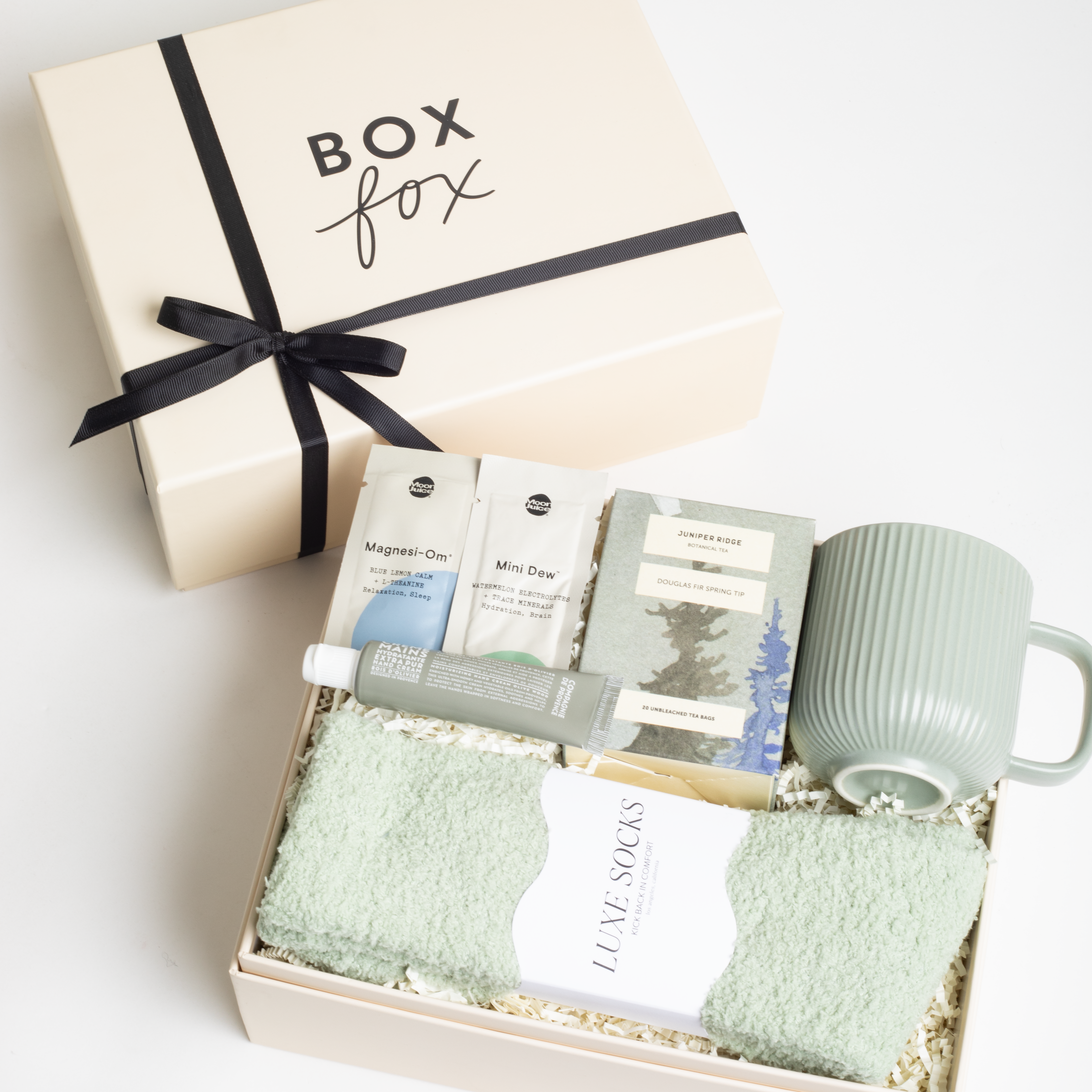 BOXFOX HEAL Gift Box with a magnesium &amp; electrolyte packet, a travel hand cream, douglas fir spring tip tea, a sage ribbed mug, and sage cozy socks