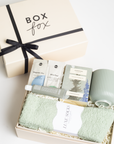 BOXFOX HEAL Gift Box with a magnesium & electrolyte packet, a travel hand cream, douglas fir spring tip tea, a sage ribbed mug, and sage cozy socks