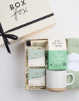 BOXFOX HEAL Gift Box with 2 shower steamers, a travel hand cream, mint & lavender tea, a speckled ceramic mug, and sage cozy socks