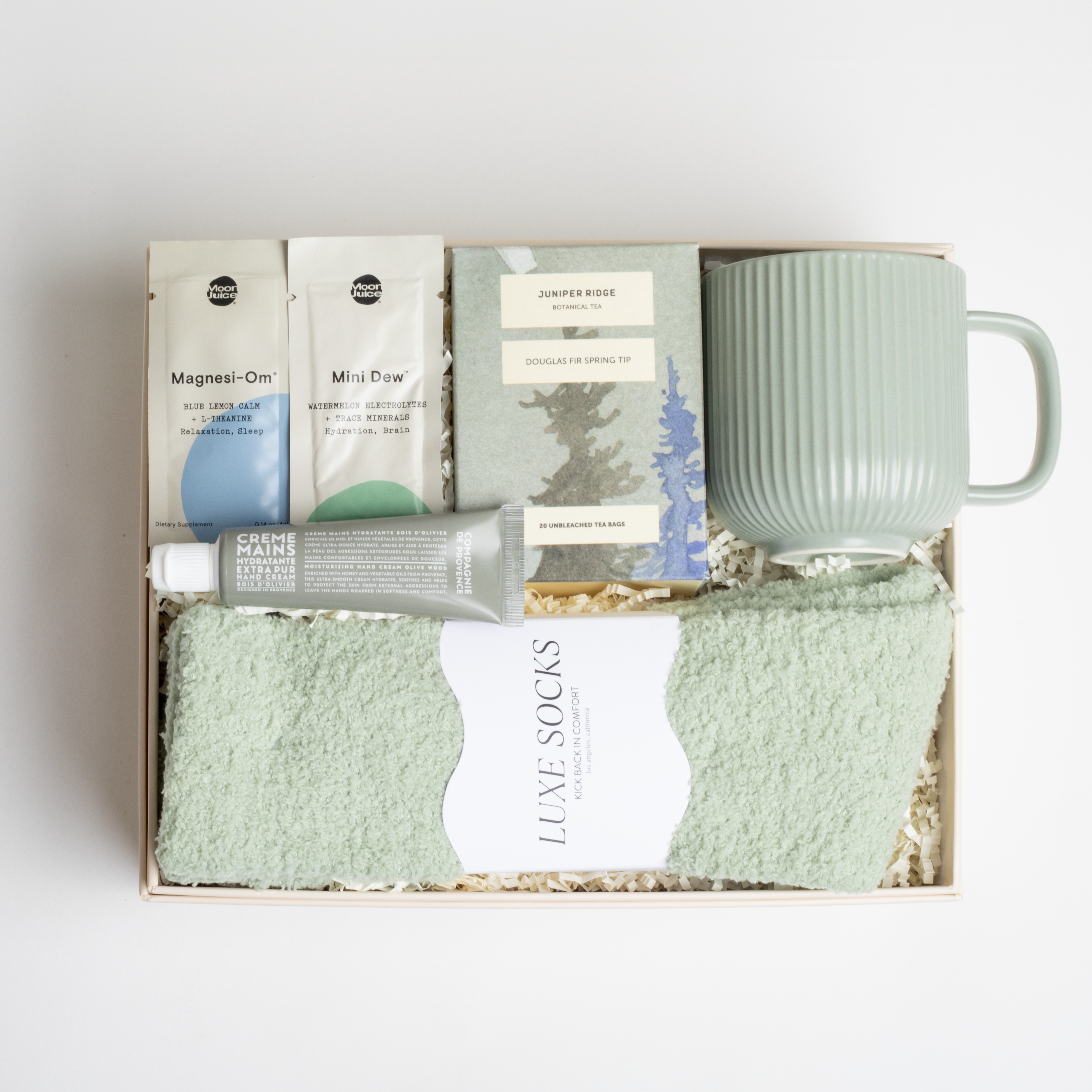 BOXFOX HEAL Gift Box with a magnesium &amp; electrolyte packet, a travel hand cream, douglas fir spring tip tea, a sage ribbed mug, and sage cozy socks