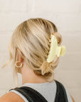 yellow clip in blonde hair