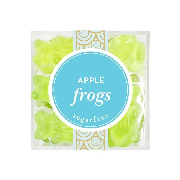 cube box with blue sticker on the front with white text. green gummy frogs inside 