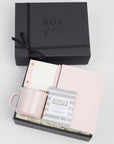 BOXFOX black Hustle Gift Box packed with Wit & Delight Pink Note to Self Journal, BOXFOX Pink Ceramic Mug, Well-Kept Hampton Tech Wipes, Sugarpaper Pink To Do Pad, and BOXFOX Pink Bullet Pen.