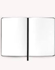 An open blank notebook with two white pages and a thin black center seam, shown on a plain light background.