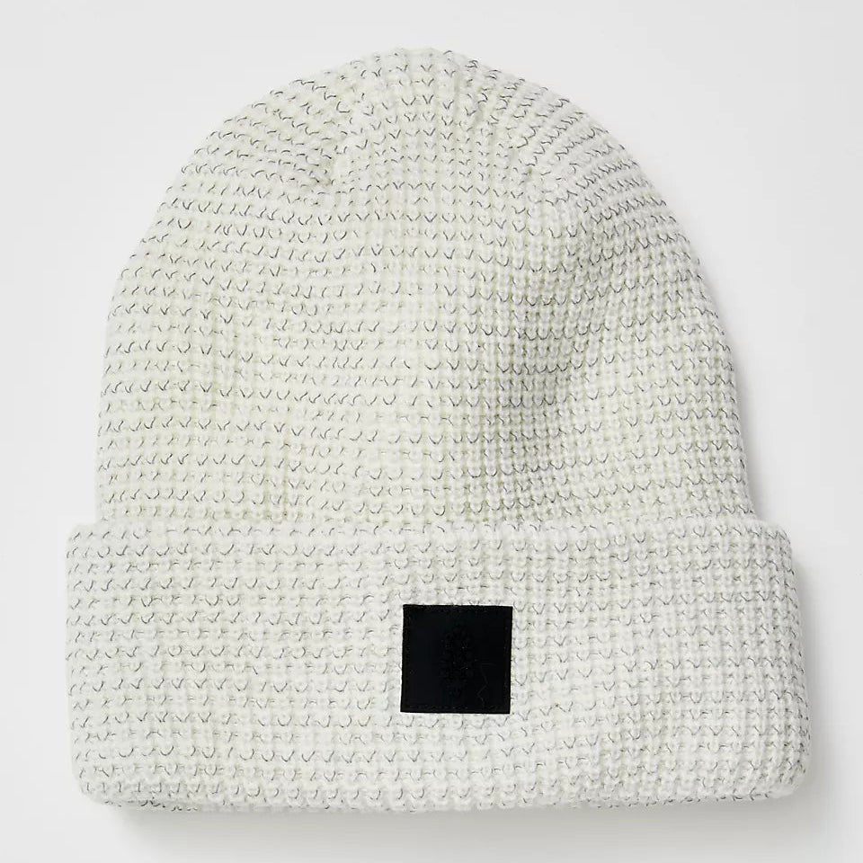 White textured beanie with a black square patch on a white background