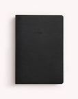 A black hardcover notebook with a minimalist design and the word 'notes' embossed on the front, shown on a light off-white background.