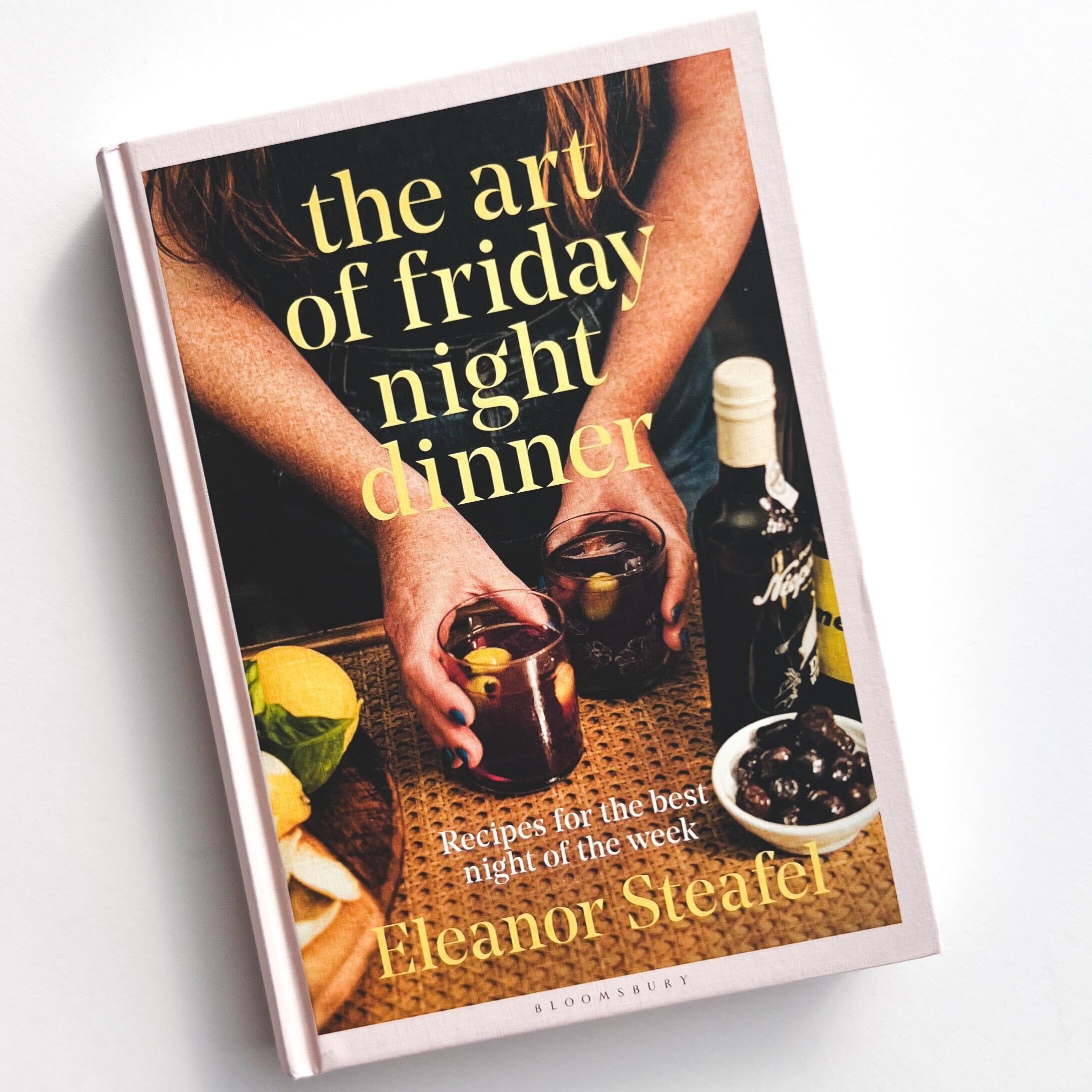 Cover of the art of friday night dinner with hands holding drinks in each