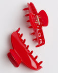 2 bright red claw clips