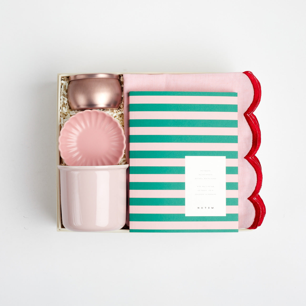BOXFOX Creme gift box packed with voluspa sparkling rose candle, pink scallop trinket tray, pink mug, green and pink stripe notem and pink two tone scallop tea towel