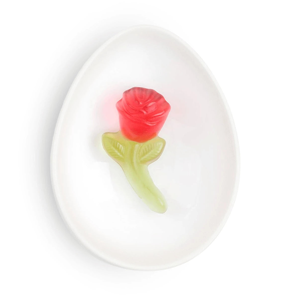 red rose gummy with green stem on white dish