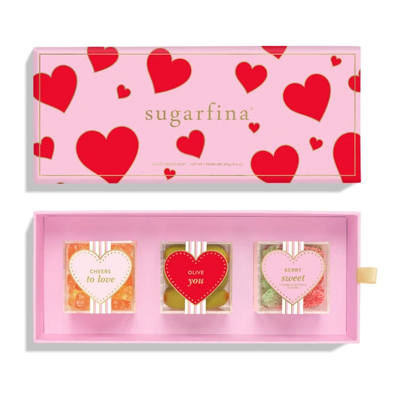 pink box with red hearts on it with 3 candy cubes inside filled with different candies