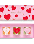 pink box with red hearts on it with 3 candy cubes inside filled with different candies