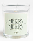 glass candle that has a light green label that says "MERRY MERRY" on it