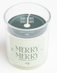 Candle in a glass jar with 'Merry Merry' label on a white background