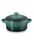 Green ceramic pot with lid on a white background