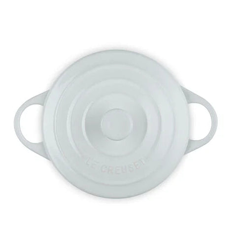 White round Dutch oven with lid on a white background