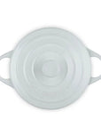 White round Dutch oven with lid on a white background