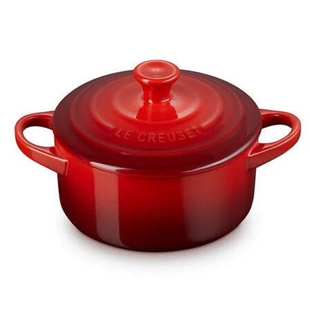 Red round Dutch oven with lid on a white background