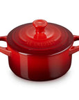 Red round Dutch oven with lid on a white background