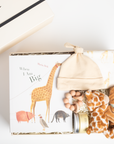 children's book, giraffe onesie, yellow hat, teether, baby lotion, and giraffe soother packed in a creme BOXFOX