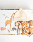 children's book, giraffe onesie, yellow hat, teether, baby lotion, and giraffe soother packed in a creme BOXFOX