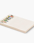 side view of white notepad. white notepad with signature floral accentuating the word "NOTES" at the top!