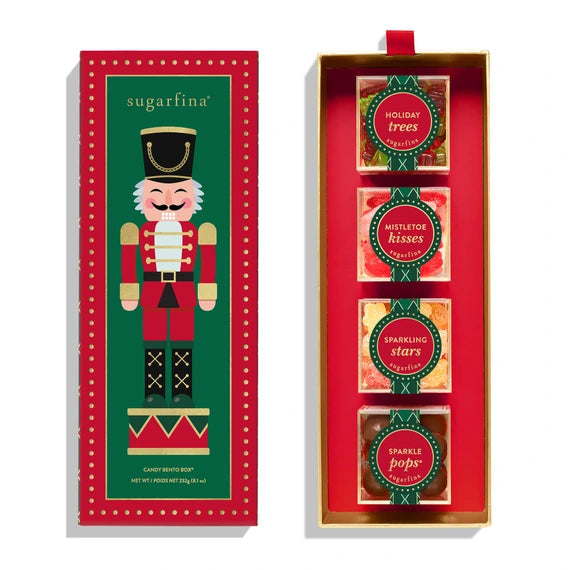 box with image of a nutcracker on it. inside are 4 candy cubes: holiday trees, mistletoe kisses, sparkling stars, and sparkle pops