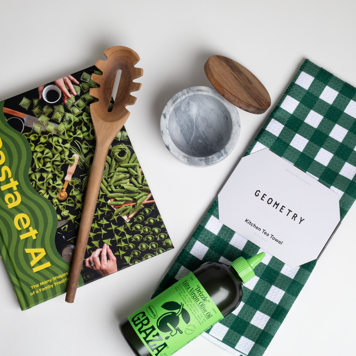 PASTA ET AL gift box which includes: Pasta Et Al cookbook, Wooden Pasta Spoon, Graza "Drizzle" Olive Oil, Geometry Green Checkered Tea Towel, and Marble Salt Cellar with wooden top