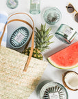 woven bag with pineapple, watermelon, towel surrounded by Casa Pacifica collection.