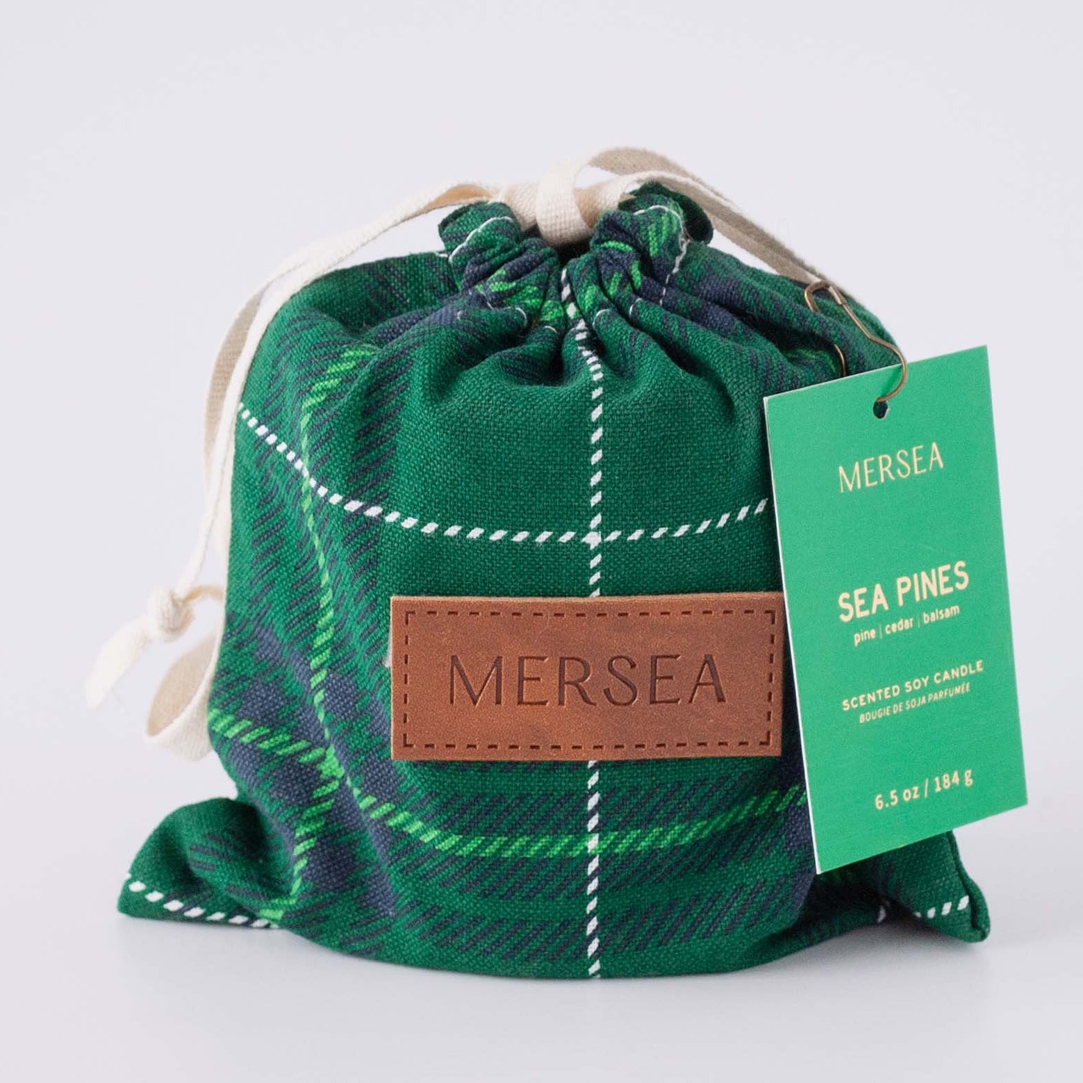 Green plaid drawstring bag with a Mersea label on a light gray background