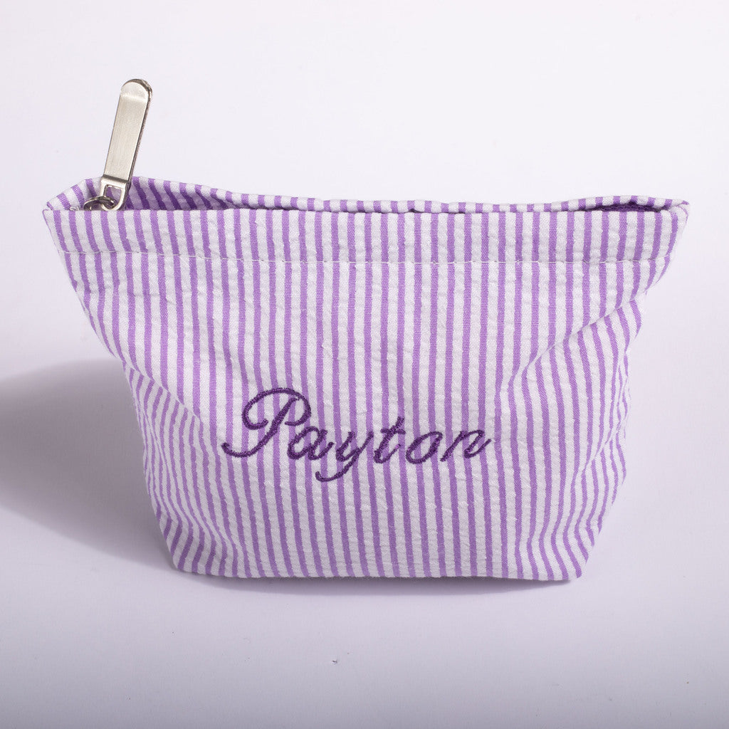 A lavender and white vertically striped fabric pouch with 'Payton' embroidered in purple script on the front, featuring a silver metal zipper pull, set against a plain white background.