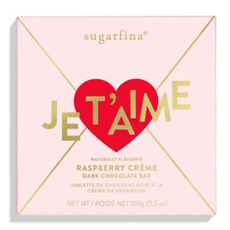 pink letter shaped chocolate bar packaging with red heart seal that says Je T'aime across it in gold