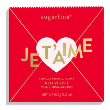 red letter shaped chocolate bar packaging with pink heart seal that says Je T'aime across it in gold