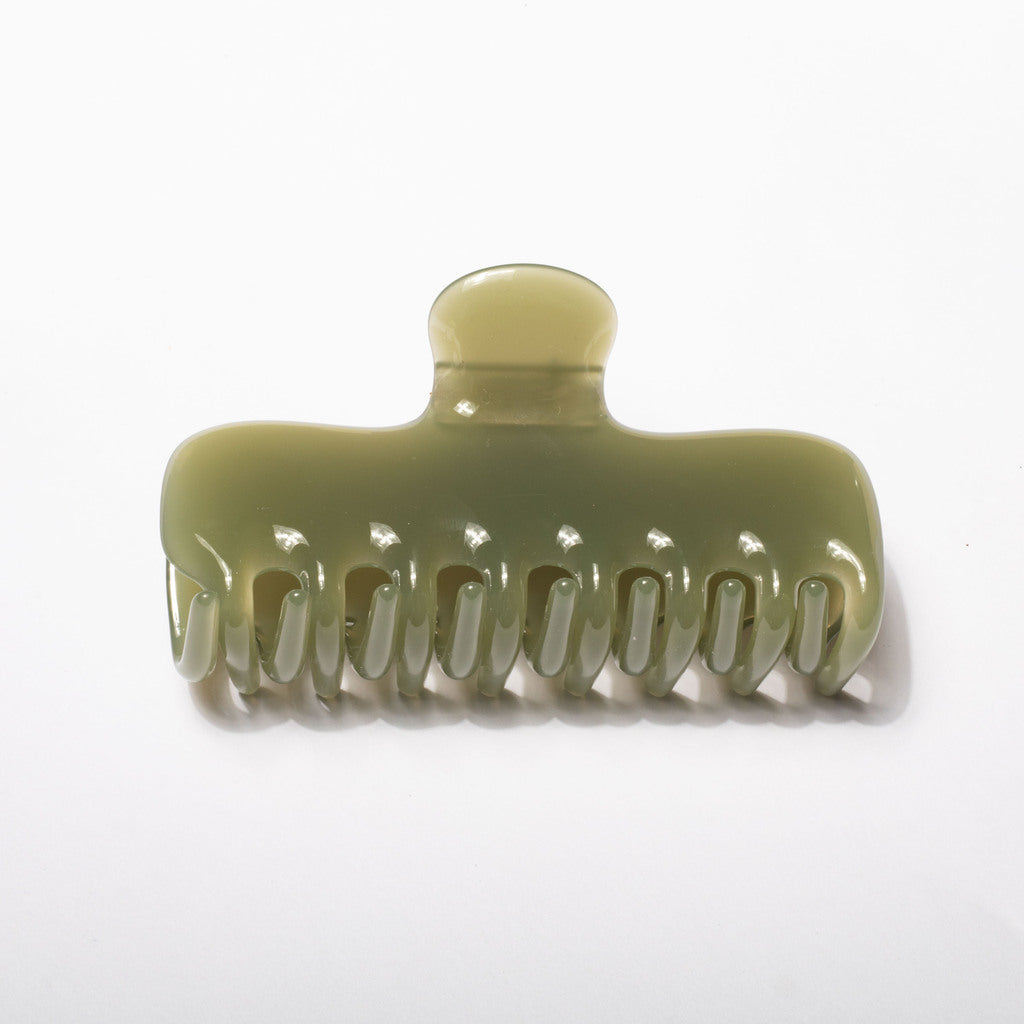 A translucent olive green hair claw clip on a clean white background.
