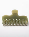 A translucent olive green hair claw clip on a clean white background.
