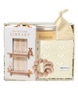 Baby product set with 'Our Very Little Library' packaging, including a bottle, bib, and rattle.