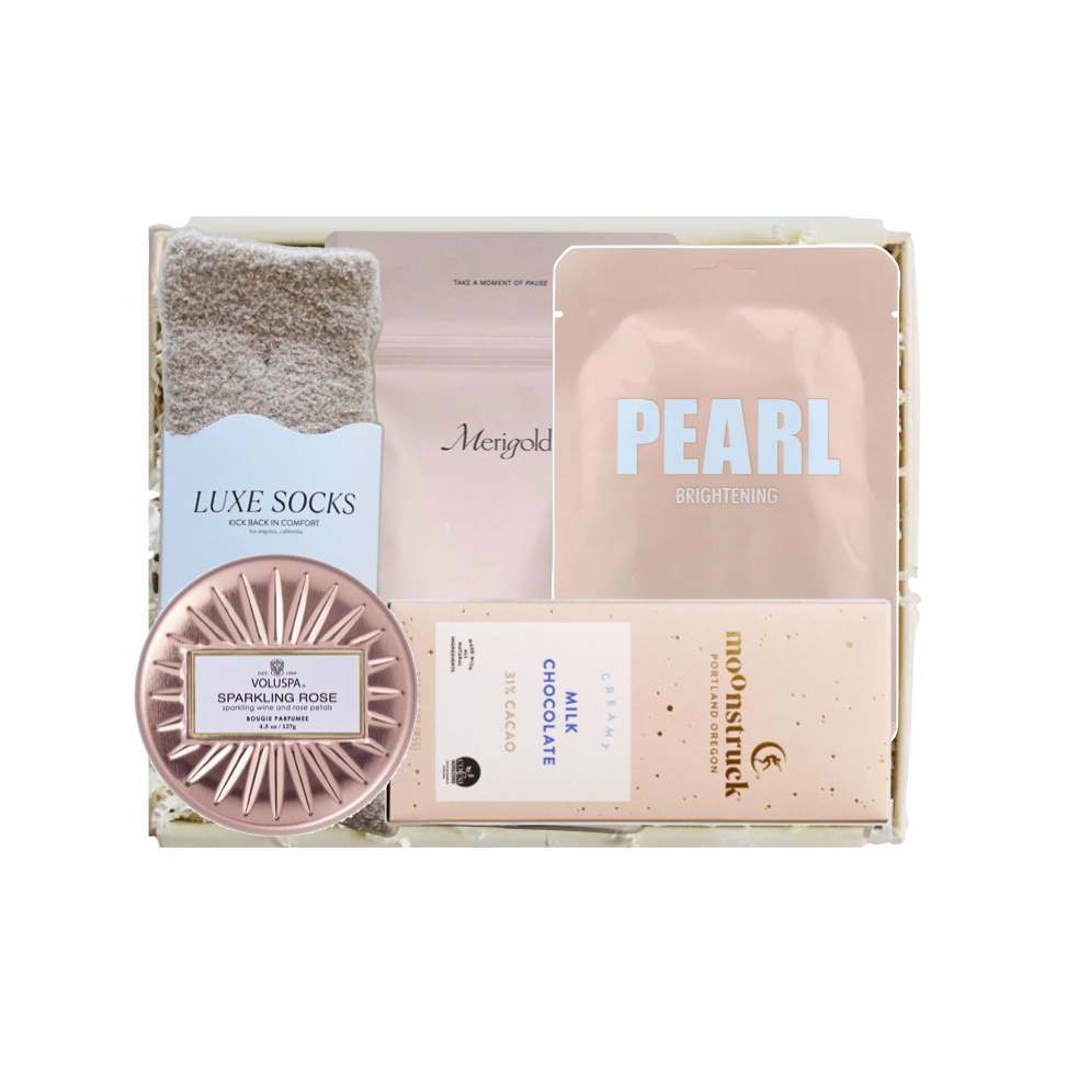 Gift set with socks, chocolate, and other items in a box on a white background