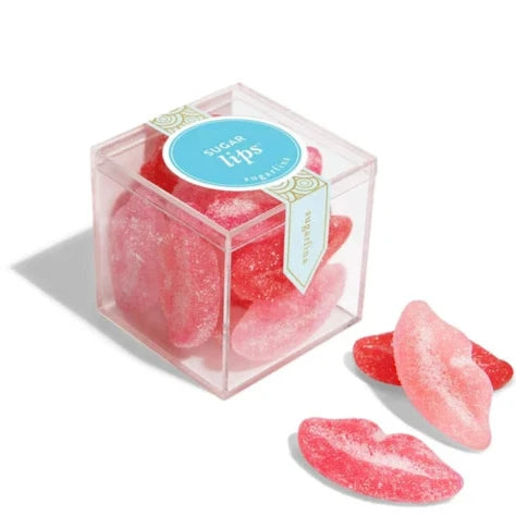 Clear plastic cube with pink and red sugar lips inside