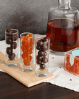 Bourbon Bears in candy cube next to shot glasses full of candy and whiskey decanter in the background