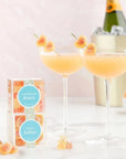 Peach Bellini Candy in champagne cocktail and next to packaging